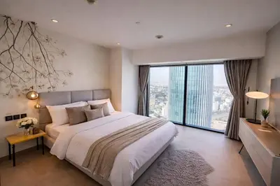 a bedroom with a large bed and a large window at Skyline Residence Apartment Stunning City Views in Amman