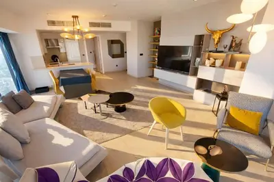 a living room with a couch and chairs at Skyline Residence Apartment Stunning City Views in Amman