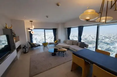 a living room with a couch and a table at Skyline Residence Apartment Stunning City Views in Amman