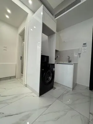 a kitchen with a washing machine in a room at Boulevard Comfort Haven, apt with stunning veiw in Amman