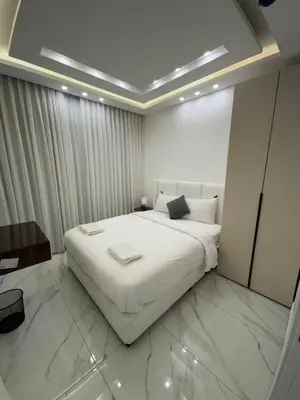 a bedroom with a large white bed in a room at Boulevard Comfort Haven, apt with stunning veiw in Amman