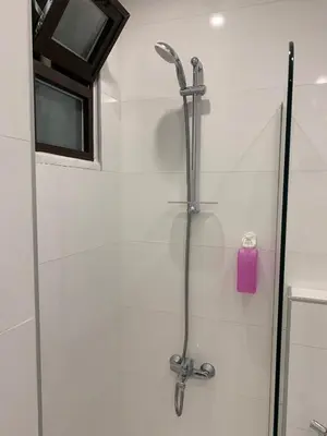a shower with a shower head in a bathroom at Boulevard Comfort Haven, apt with stunning veiw in Amman