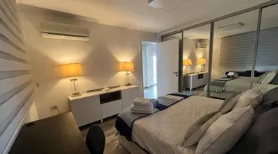 a bedroom with a large bed and a mirror at An Overlooking Rooftop in Amman in Amman