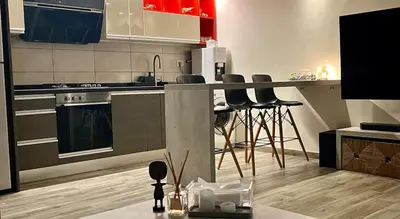 a kitchen with a counter and some bar stools at An Overlooking Rooftop in Amman in Amman