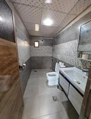 a bathroom with a toilet and a sink at Starlit Wadi Rum camp in Wadi Rum