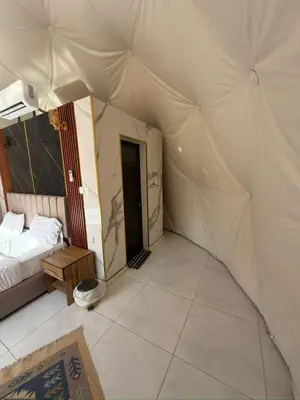 a bedroom with a bed and a tent at Dune Horizon Camp in Wadi Rum