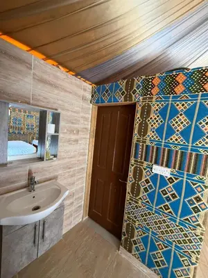 a bathroom with a sink and a mirror at Dune Horizon Camp in Wadi Rum