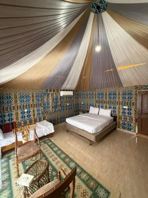a bedroom with a bed in a tent at Dune Horizon Camp in Wadi Rum