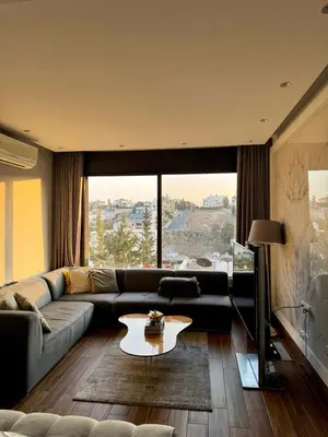 a living room with a couch and a table at Elegant & Cozy Apartment in Heart of Amman in Amman