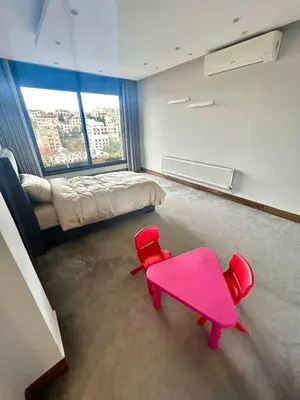 a room with a pink table and a bed at Elegant & Cozy Apartment in Heart of Amman in Amman