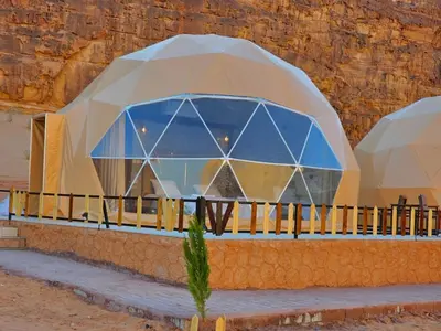 a building in a desert with a glass dome at Luxury Mars Camp in Wadi Rum