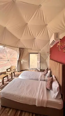 a bedroom with a large bed in a tent at Luxury Mars Camp in Wadi Rum