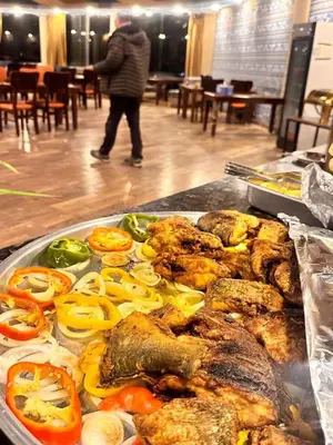 a tray of food on a table with peppers and meat at Luxury Mars Camp in Wadi Rum