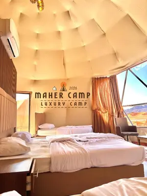 a room with two beds and a sign that says master camp luxury camp at Wadi rum maher luxury camp in Wadi Rum