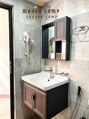 a bathroom with a sink and a mirror at Wadi rum maher luxury camp in Wadi Rum