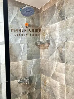 a shower with a sign that reads master game luxury game at Wadi rum maher luxury camp in Wadi Rum