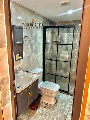 a bathroom with a toilet and a sink at Wadi rum maher luxury camp in Wadi Rum