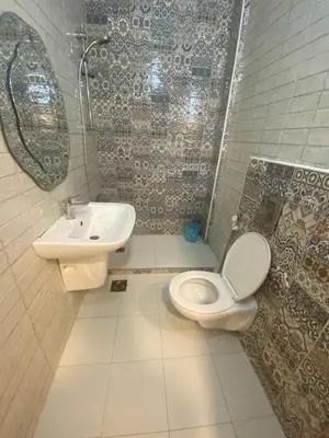 a bathroom with a toilet and a sink at studio apartment for rent in Amman