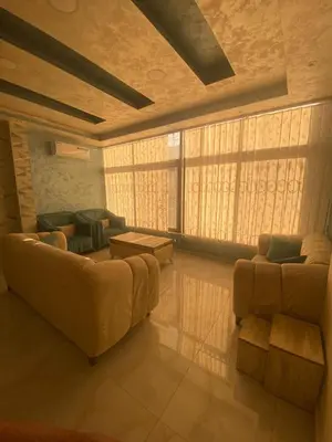 a living room with a couch and two chairs at studio apartment for rent in Amman