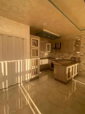 a large kitchen with a island in the middle at studio apartment for rent in Amman
