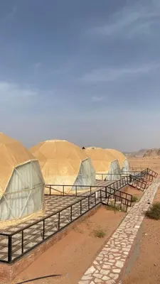 a row of domed tents in the desert at Golden Camp in Wadi Rum