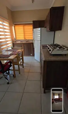 a kitchen with a table and a stove top oven at عبدالرحمن الشطناوي in Aqaba