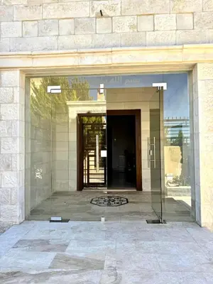 a glass window in a building with a door at Bright & Comfortable Villa in Abu Nuseir in Al Jafr