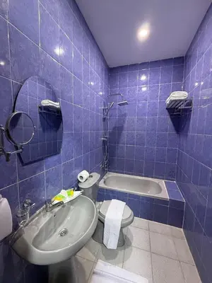 a blue tiled bathroom with a toilet and a sink at شقق سلين الفندقية in Amman
