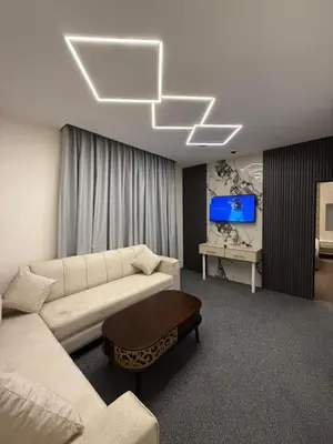 a living room with a couch and a tv at شقق سلين الفندقية in Amman