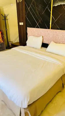 a large white bed with two pillows on it at RUM FIRAS lUXURY CAMP in Wadi Rum