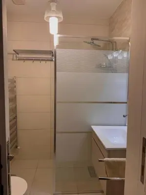 a bathroom with a sink and a toilet and a shower at Modern Apartment, Untouched & Ready to Stay in Amman