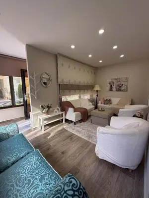 a living room with couches and a living room with a couch at Modern Apartment, Untouched & Ready to Stay in Amman