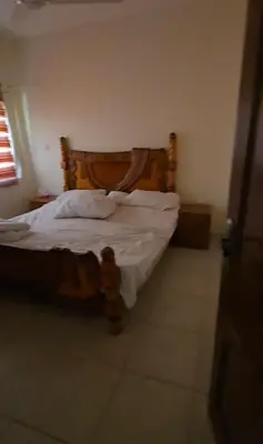 a bedroom with a bed with a wooden head board at عبدالرحمن الشطناوي2 in Aqaba