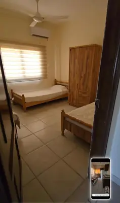 a room with two beds and a window at عبدالرحمن الشطناوي2 in Aqaba