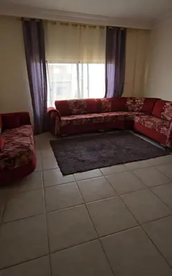 a living room with a couch and a window at عبدالرحمن الشطناوي2 in Aqaba
