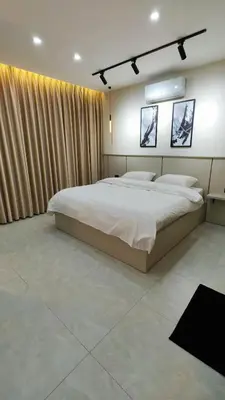a bedroom with a large white bed and curtains at LaPerla Rooftop family in Amman