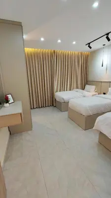 a hotel room with two beds and a window at LaPerla Rooftop family in Amman
