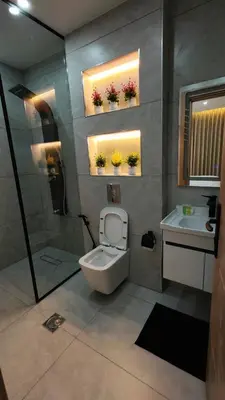 a bathroom with a toilet and a shower and a sink at LaPerla Rooftop family in Amman