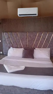 a bedroom with a bed with avertisementatronatronatronstrationstrationstration at DESERT PULSE lUXURY CAMP in Wadi Rum