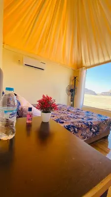 a bedroom with a bed and a bottle of water at Essam camb in Disah