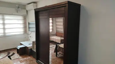 a room with a mirror and a room with a chair at Stone house in Amman