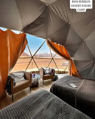 a room with two beds and a view of a desert living camp at RUM BUBBLES DESERT lUXURY CAMP in Wadi Rum