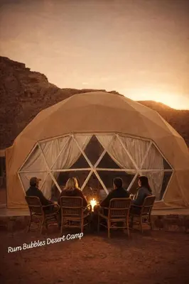 a group of people sitting around a fire in a tent at RUM BUBBLES DESERT lUXURY CAMP in Wadi Rum