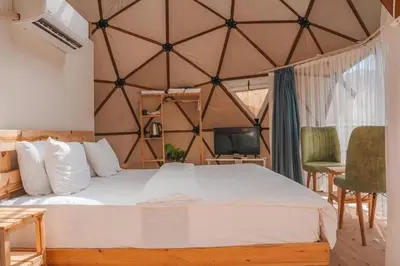 a bedroom with a large bed in a yurt at rum magic luxury camp in Wadi Rum