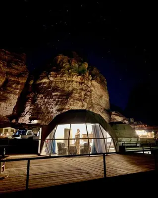 a person standing in a tent in front of a rock at rum magic luxury camp in Wadi Rum