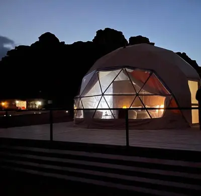 a large tent is lit up at night at rum magic luxury camp in Wadi Rum