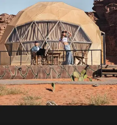 two people standing in front of a yurt at Wadi Rum Main Road Visitor Center in Disah