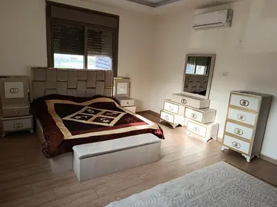 a bedroom with a bed and some night stands at شقه مفروشه للايجار بجانب الكارفور اربد in Irbid