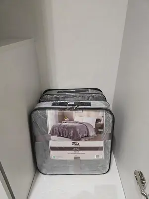 a suitcase sitting in a corner of a room at Two-bedroom family friendly modern apartment in Amman
