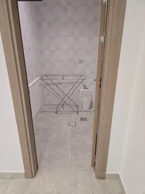 an open door to a bathroom with a tub at Two-bedroom family friendly modern apartment in Amman